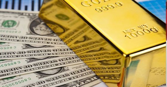 A 999.9 gold bar placed on dollar bills shows why investors buy gold in Vancouver to hedge against inflation and currency instability. 