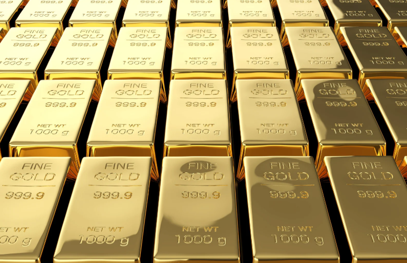 Gold bullion bars marked 999.9 fine gold and 1000g, stacked in rows.