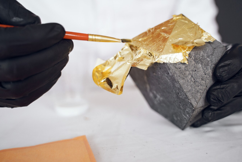 Applying gold leaf Edmonton bullion work