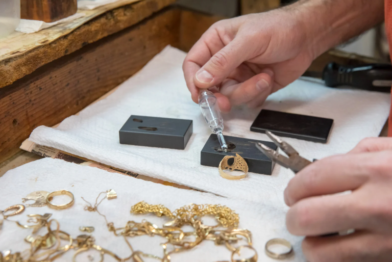 Inspecting gemstone ring Edmonton bullion