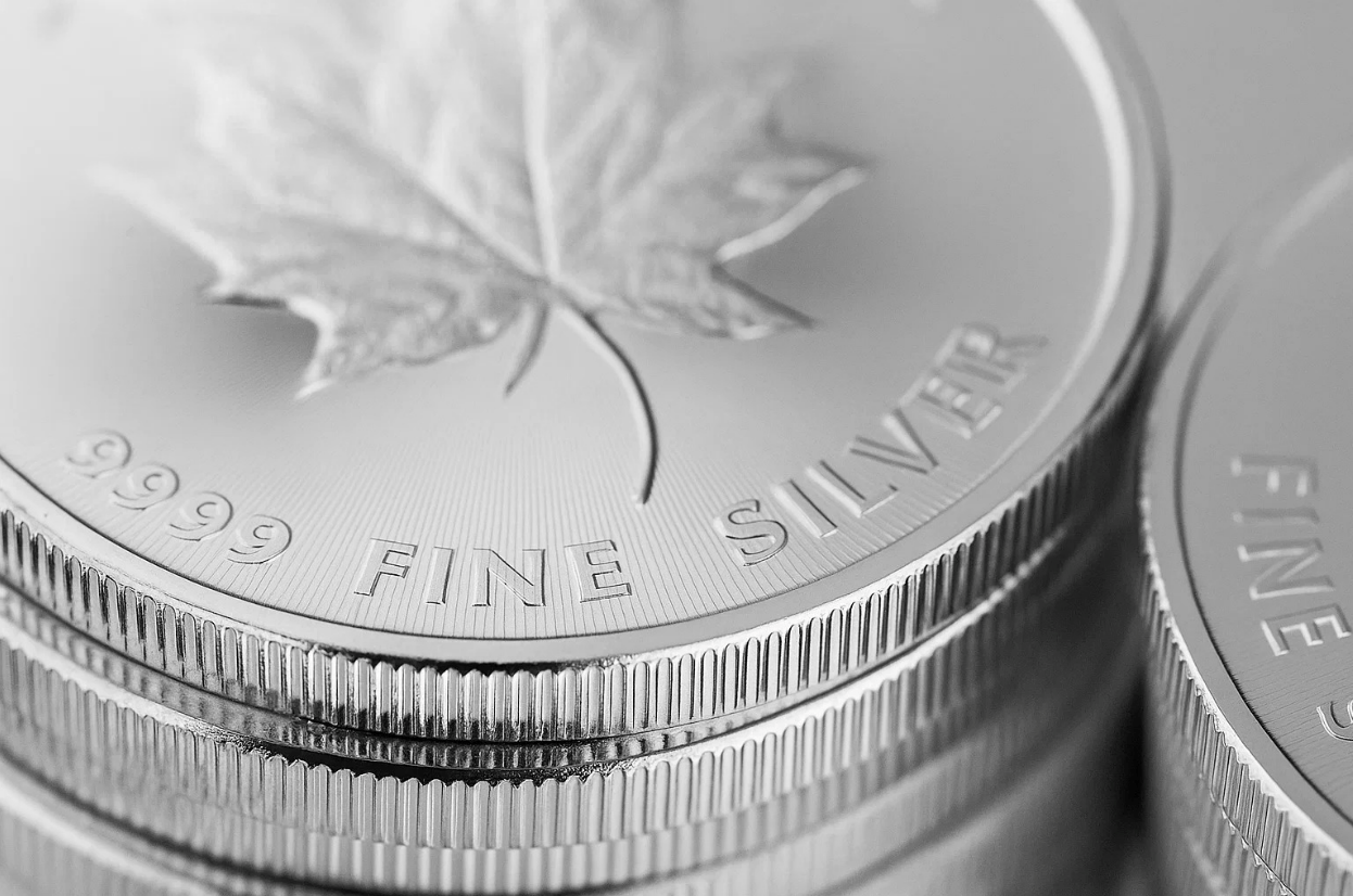 Stack of fine silver coins symbolizing silver and gold spot price trends.